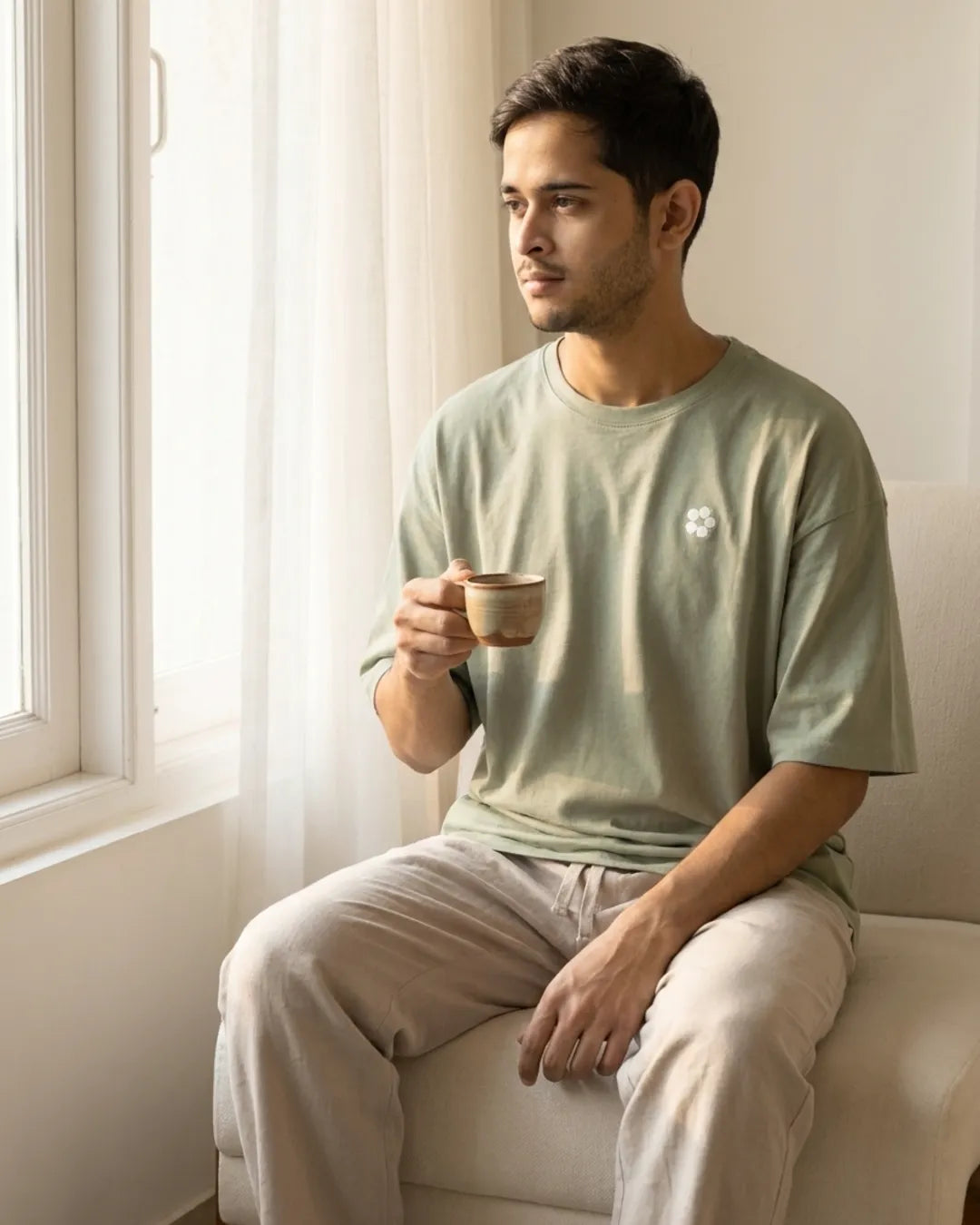 Morning chai by the window in a sage tee and linen trouser
