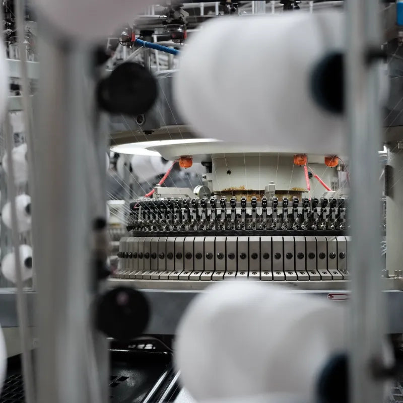 Knitting machine making fabric