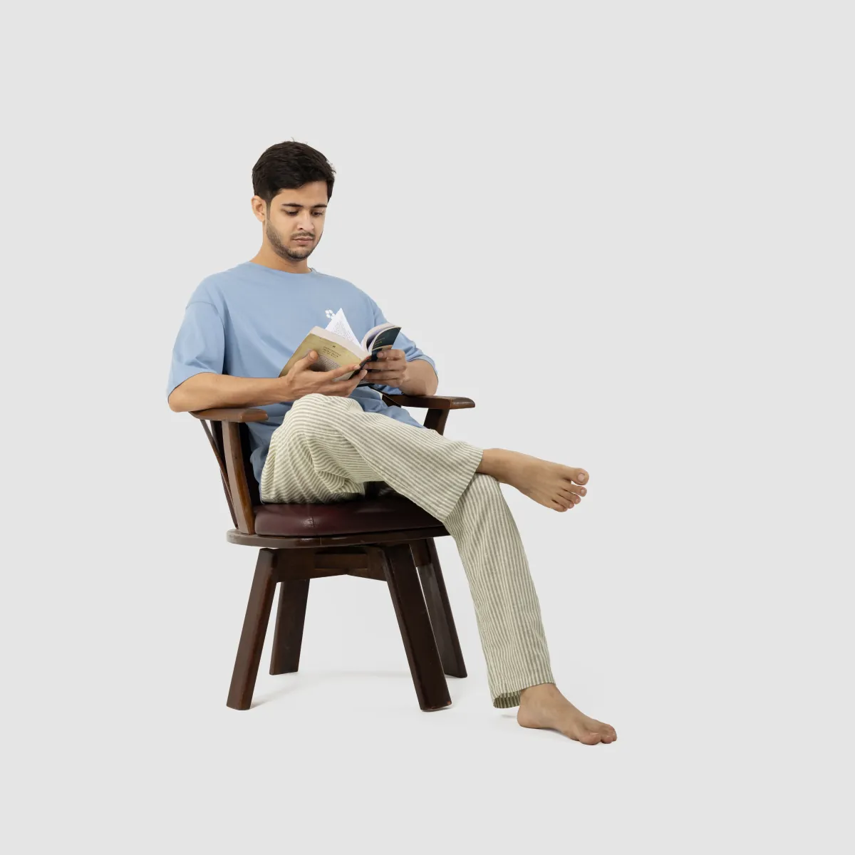 Reading at home in an AeroCotton tee and a striped linen trouser