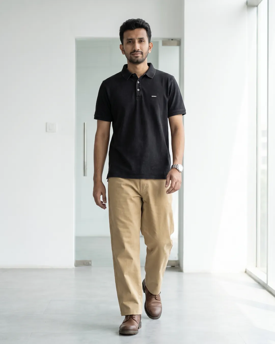 Walking out the door in a charcoal polo and khaki chino