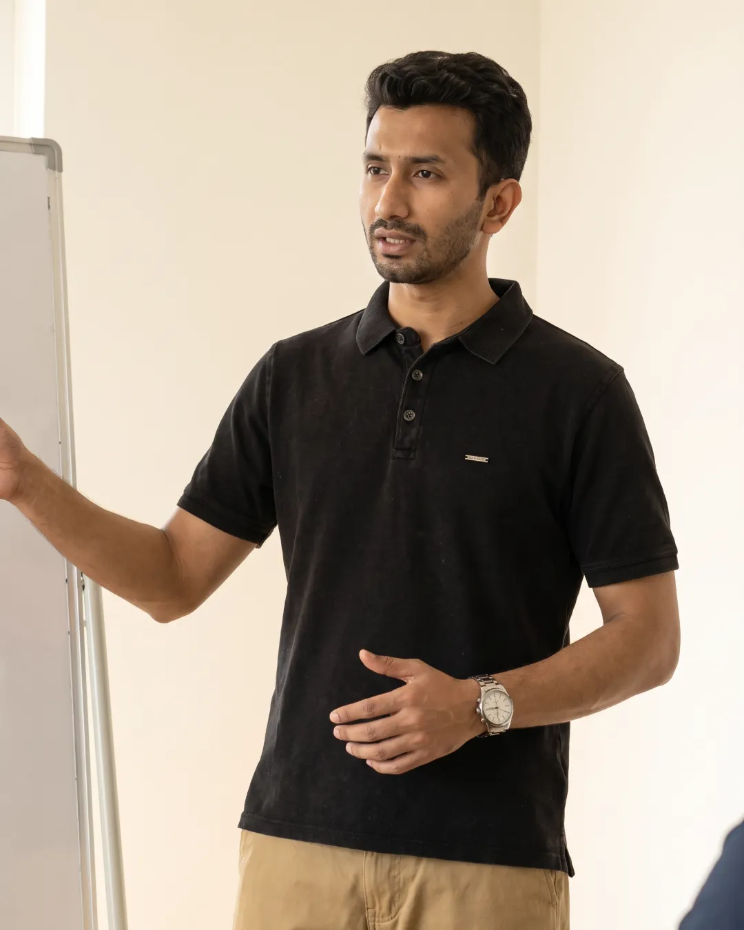Presenting in the afternoon in a charcoal polo