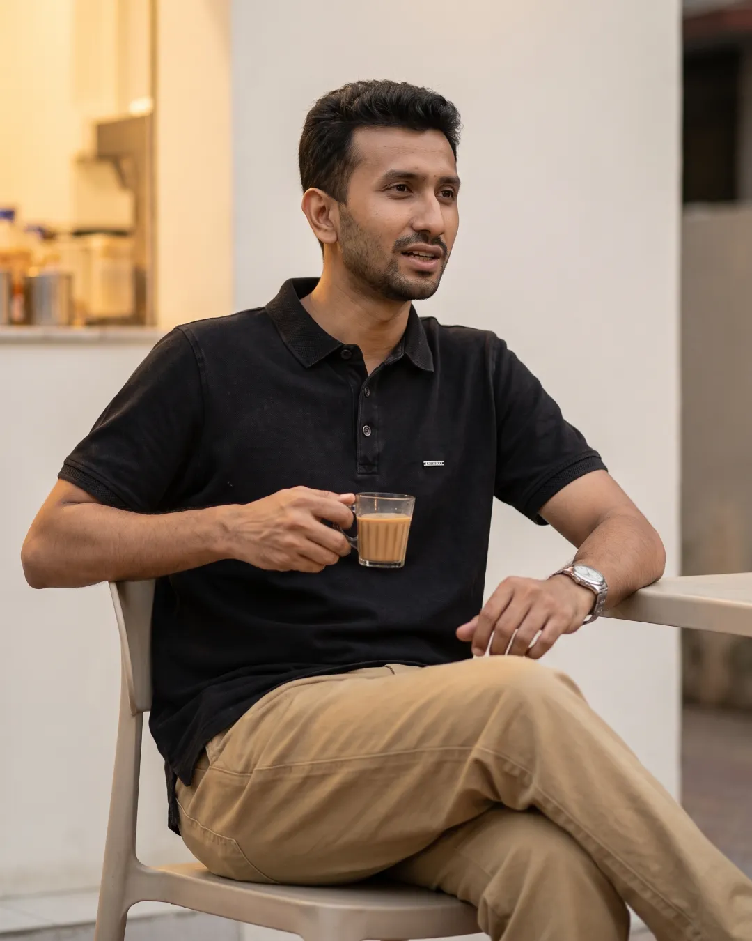 Evening adda with a cup of tea in a charcoal polo and khaki chino