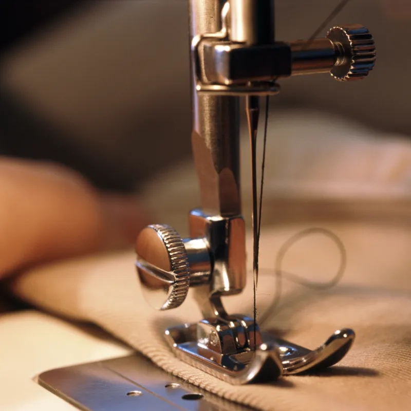 A sewing machine stitching a garment